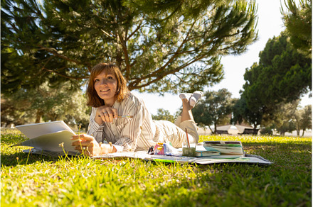 An adult smiling woman artist lying, a Person Photo by Barcelona_dreams