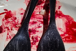 Close-up of black forks on red-smeared plate, a Food & Drink Photo by DanFLCreativo