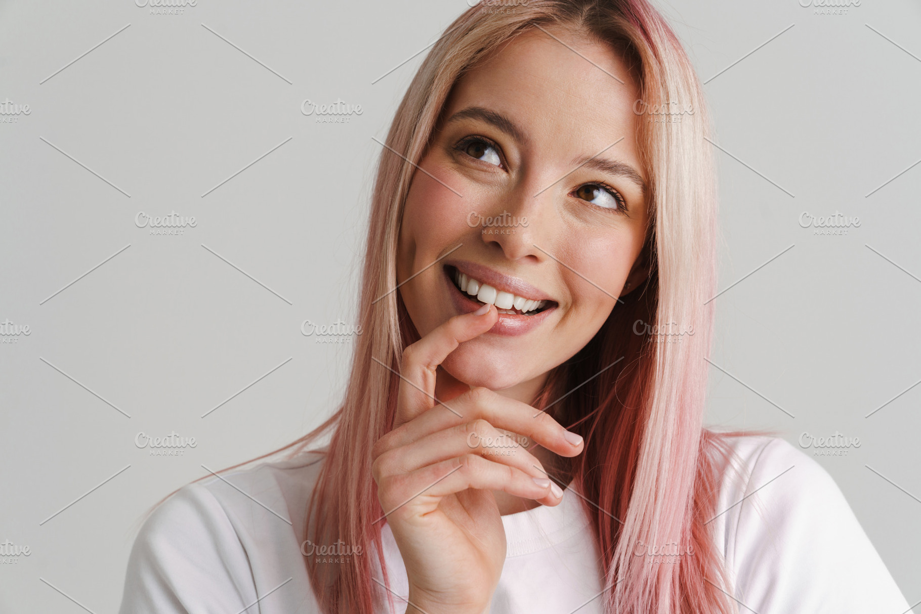 Young woman with pink hair smiling and looking aside, a Person Photo by Dean Drobot