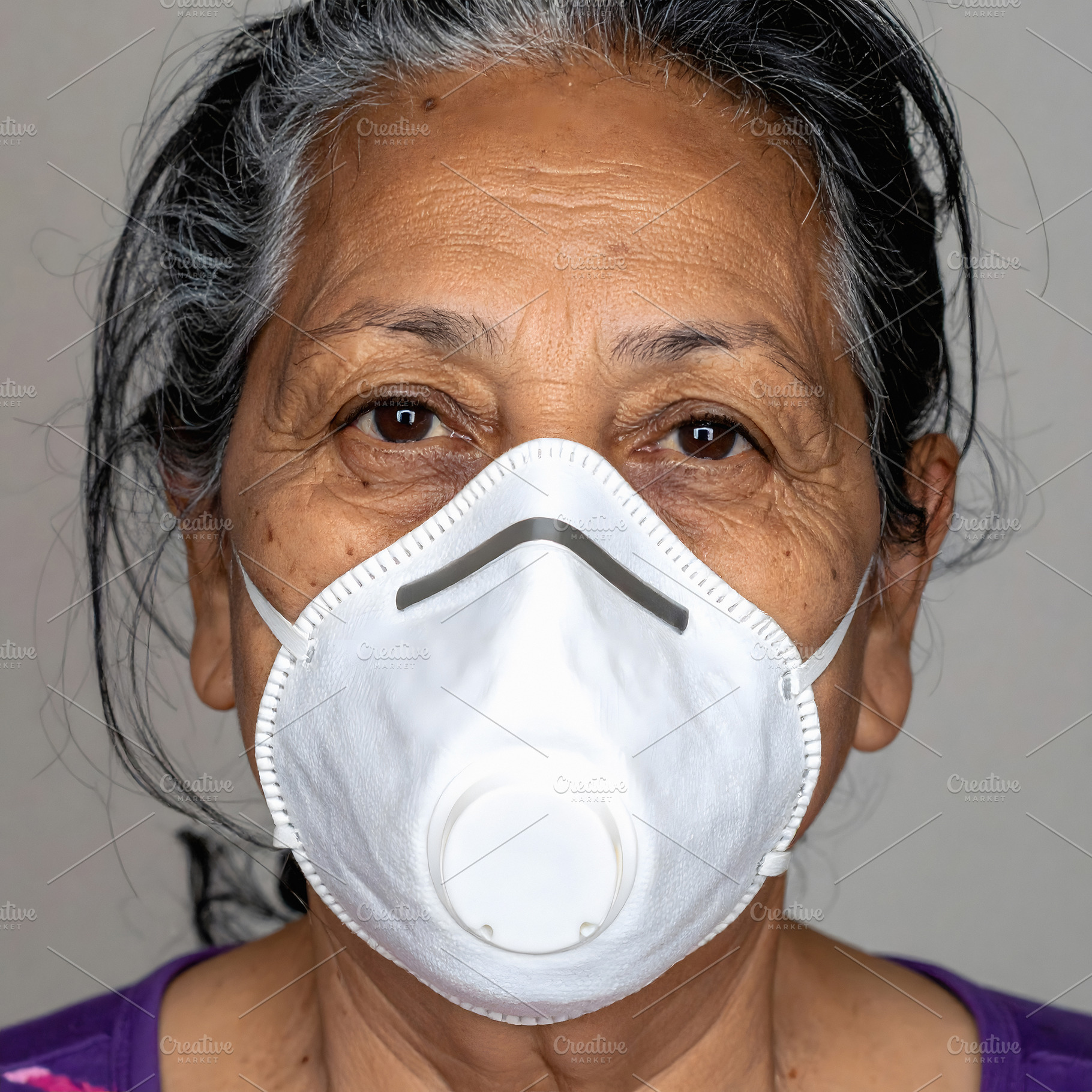 Senior woman wearing white protective breathing mask, a Health & Medical Photo by GoodGoods