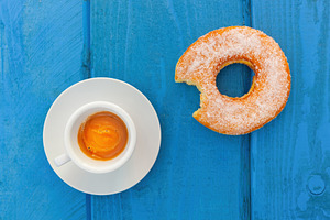 Sugary donut and espresso coffee resting on a blue wooden table for breakfast, a Food & Drink Photo by Antonio Gravante Market