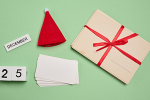 Set of Christmas elements: red Santa hat, cards, blank cards and, a Holiday Photo by ndanko