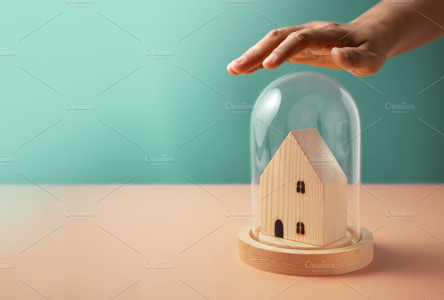 Hand covering small wooden house under glass dome, Home insuranc, a Photo by salmon.black