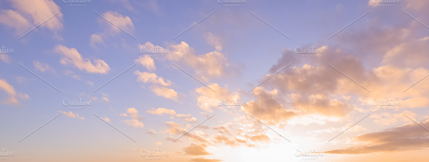 Golden hour sky presenting soft pastel clouds during sunset capturing beauty of, a Photo by Studio ANNA