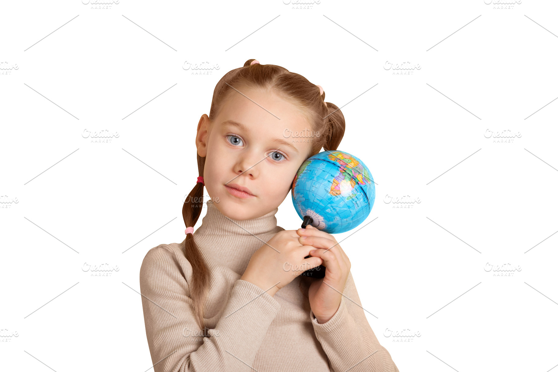 Young girl with pigtails gently holding a small globe, symbolizi, a School & Education Photo by Ales Munt