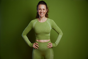 Smiling woman in green activewear, a Person Photo by Alliance Images