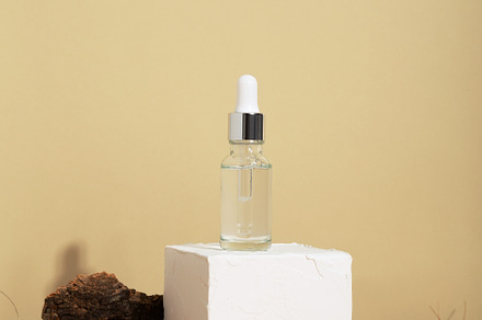 Bottle white glass with dropper on beige background. Natural cos, a Beauty & Fashion Photo by matucha
