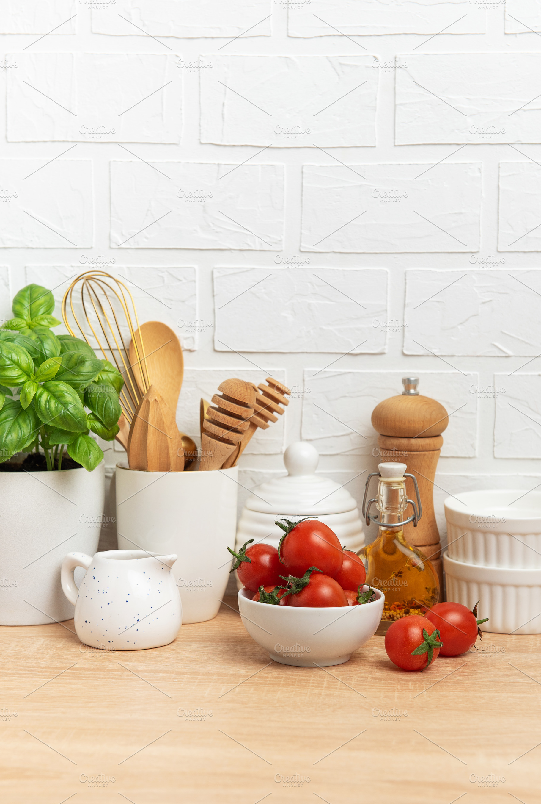 Kitchen utensils, fresh tomatoes, basil and olive oil creating a, a Food & Drink Photo by Olena Rudo