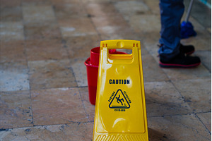 Wet floor caution sign standing on a, an Industrial Photo by volodymyrshtun13795