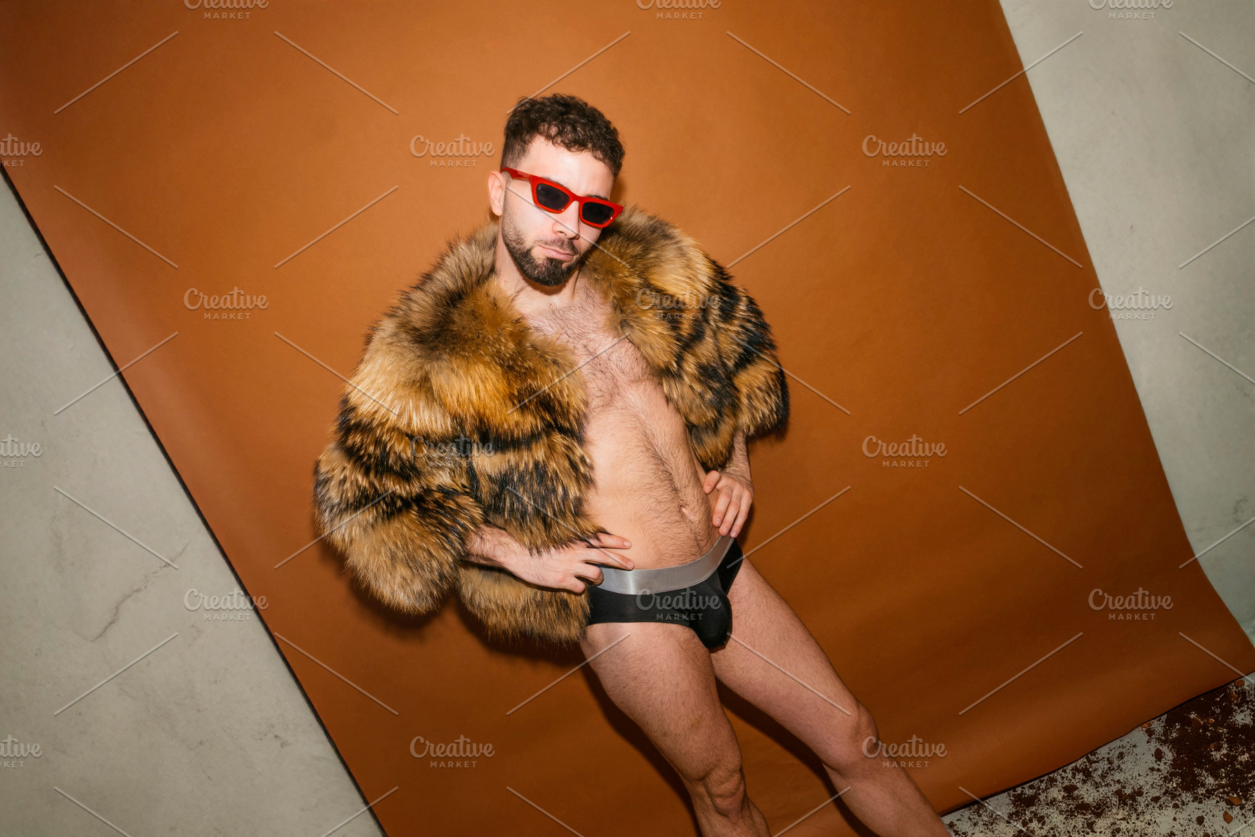 Man wearing fur coat posing for pride concept, a Photo by karrastock