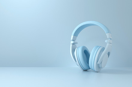 Headphones on blue background., a Technology Photo by Zama Studio