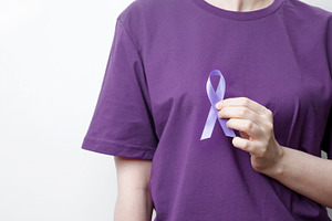 Purple ribbon held by a person in a purple shirt, symbol of support. Purple Epi, a Photo by matucha