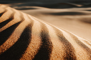 Dunes with soft shadows at sunset, a Photo by Beautiful things