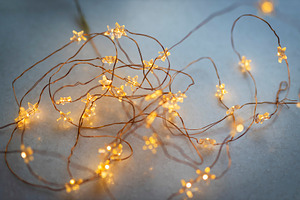 Warm yellow star-shaped fairy lights, a Wallpaper Photo by Imaginarium