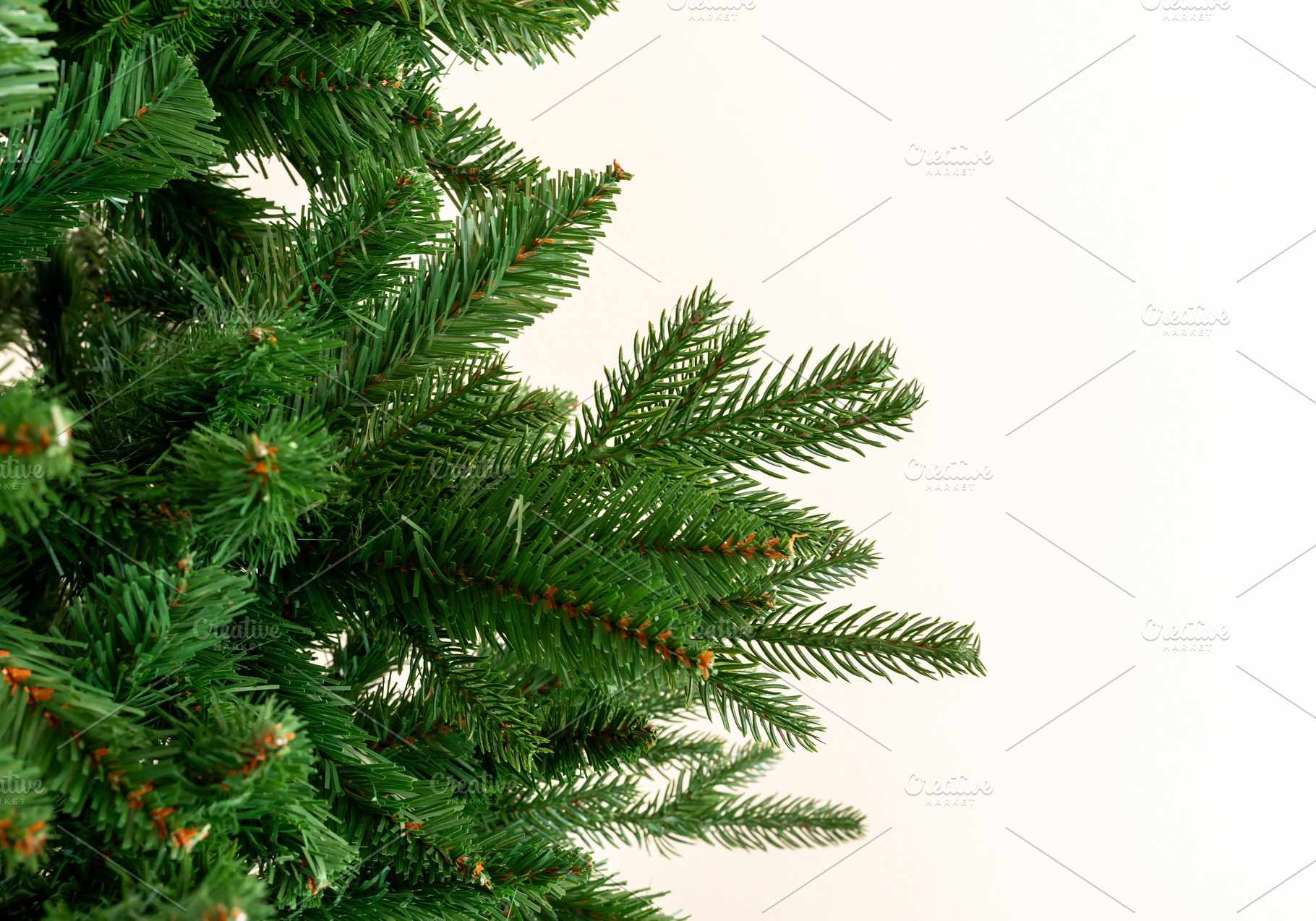 Bare synthetic Christmas tree branches creating background, a Holiday Photo by Antonio Gravante Market