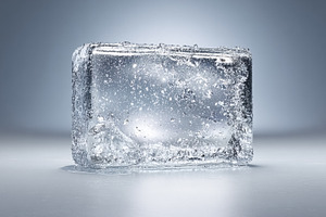 Ice cube melting on a reflective surface showing refreshing cold, a Photo by Studio ANNA
