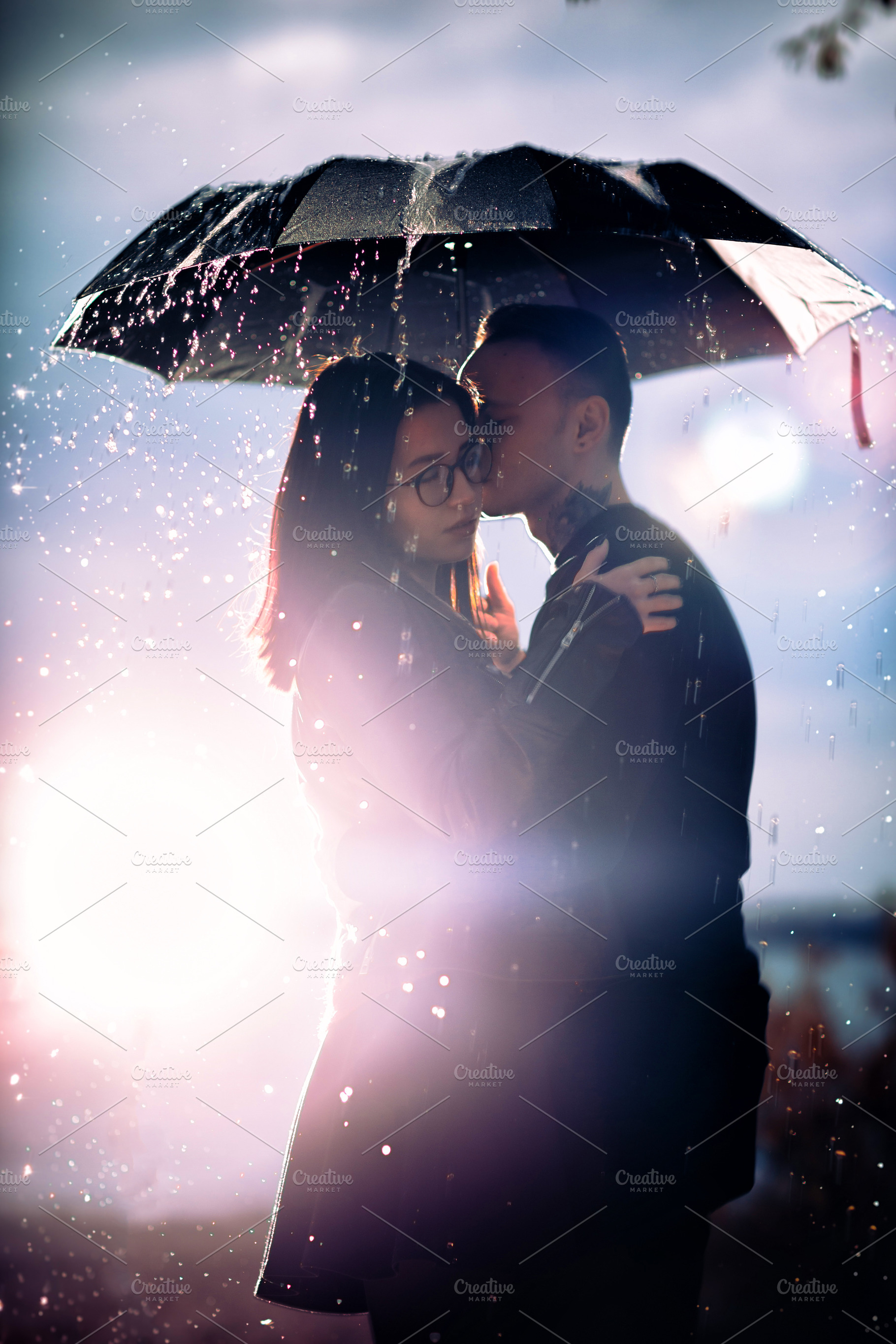 Young man and woman under an umbrell featuring city, couple, and female, a Person Photo by ruslan117