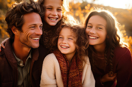 A close - up photo of a beaming American family huddled together, a Person Photo by designvectx