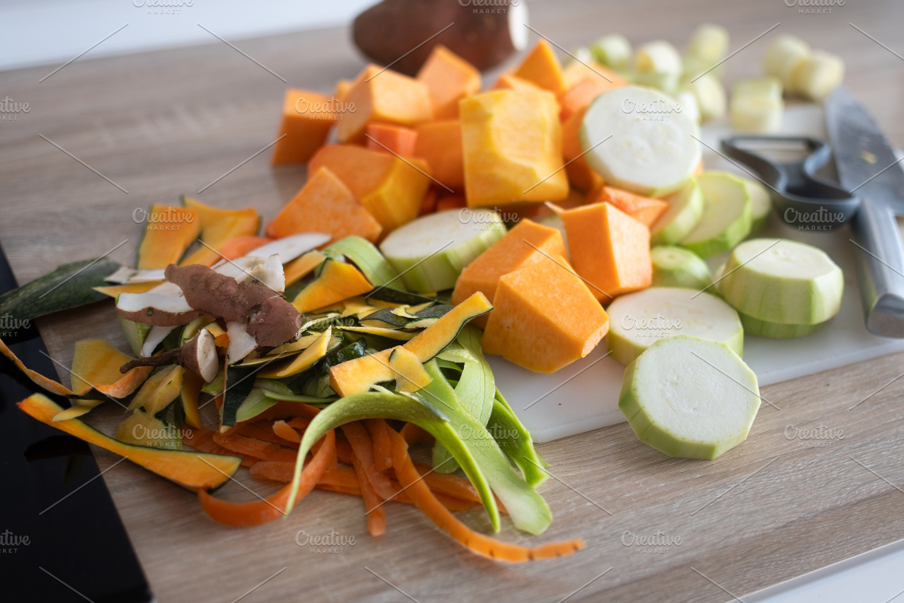 Top view of fresh vegetables being chopped on cutting board in home kitchen, a Food & Drink Photo by etorres69