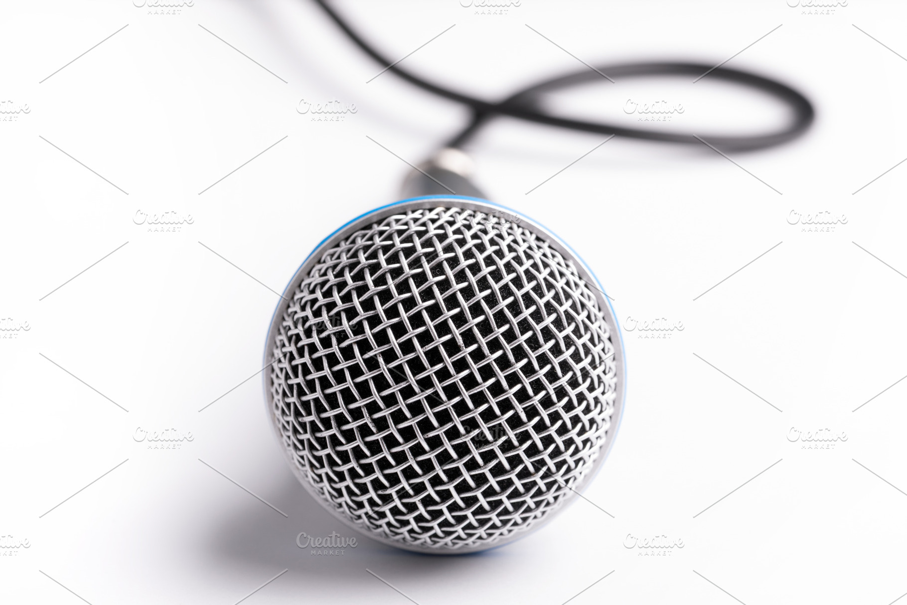 Close-up of a microphone with black cable on a clean white backg, a Business Photo by Ales Munt