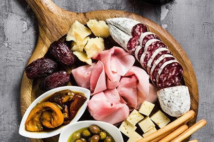 Italian snack and antipasti on a tray and red wine: prosciutto,, a Food & Drink Photo by IriGri
