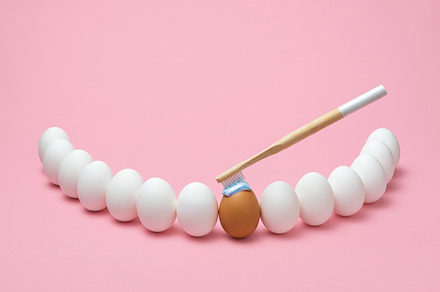 Brushing teeth concept. Oral hygiene using wooden toothbrush, a Health & Medical Photo by YesPhotographers