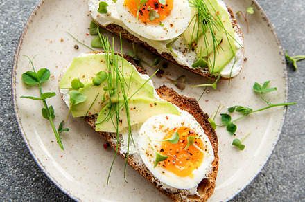 Bread toast, boiled eggs, avocado slice, microgreens on a plate, a Food & Drink Photo by Olena Rudo