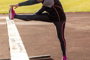 Athlete woman stretching leg