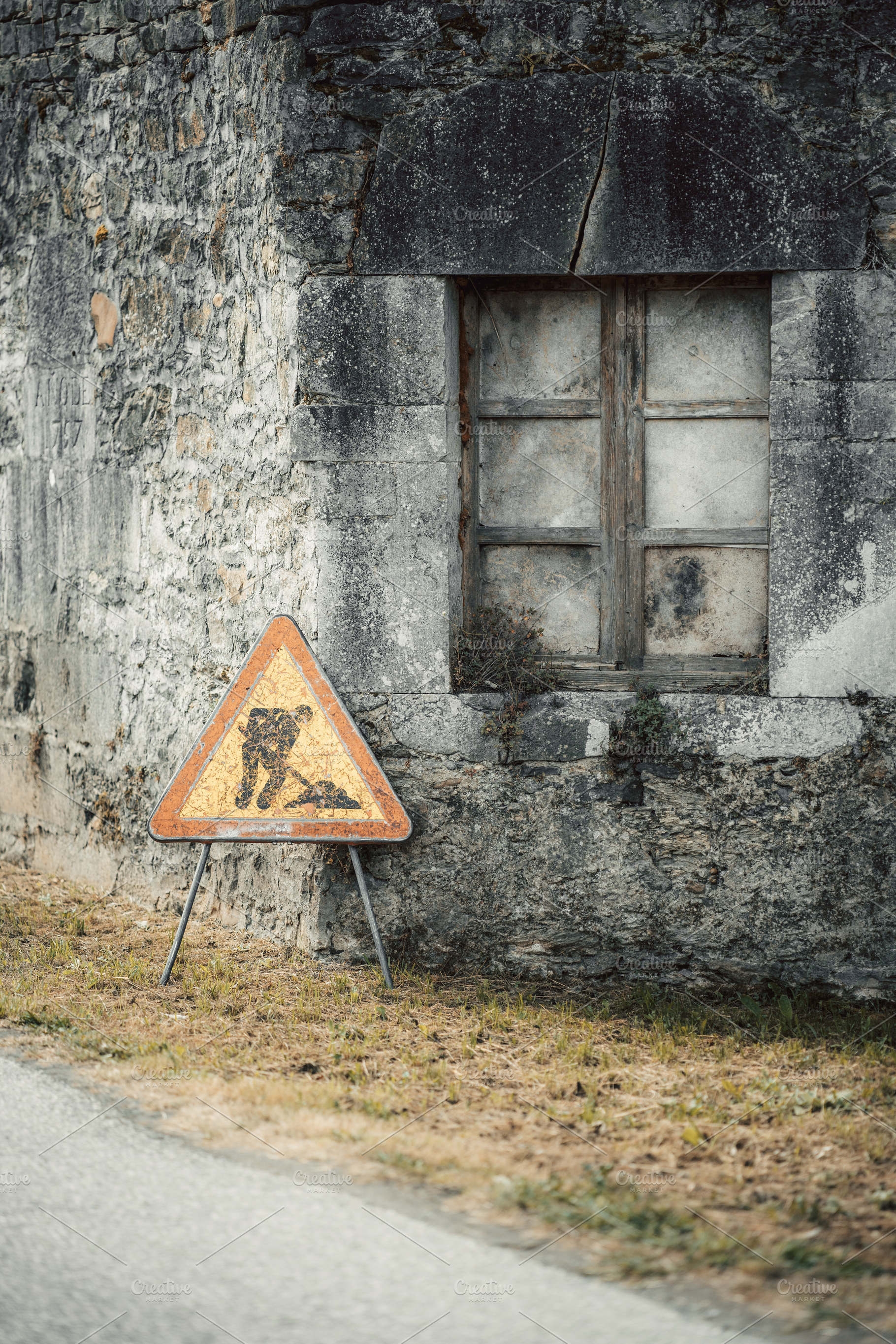 Roadwork sign by stone wall, a Transportation Photo by SkyNext