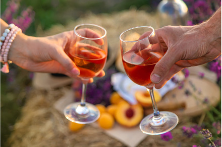 Wine in glasses is held by a woman, a Person Photo by yanadjana