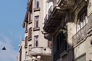 Historic city corner with ornate balconies, an Architecture Photo by DanFLCreativo