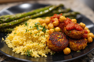 Vegan dish with couscous, chickpea, a Food & Drink Photo by MistyDay