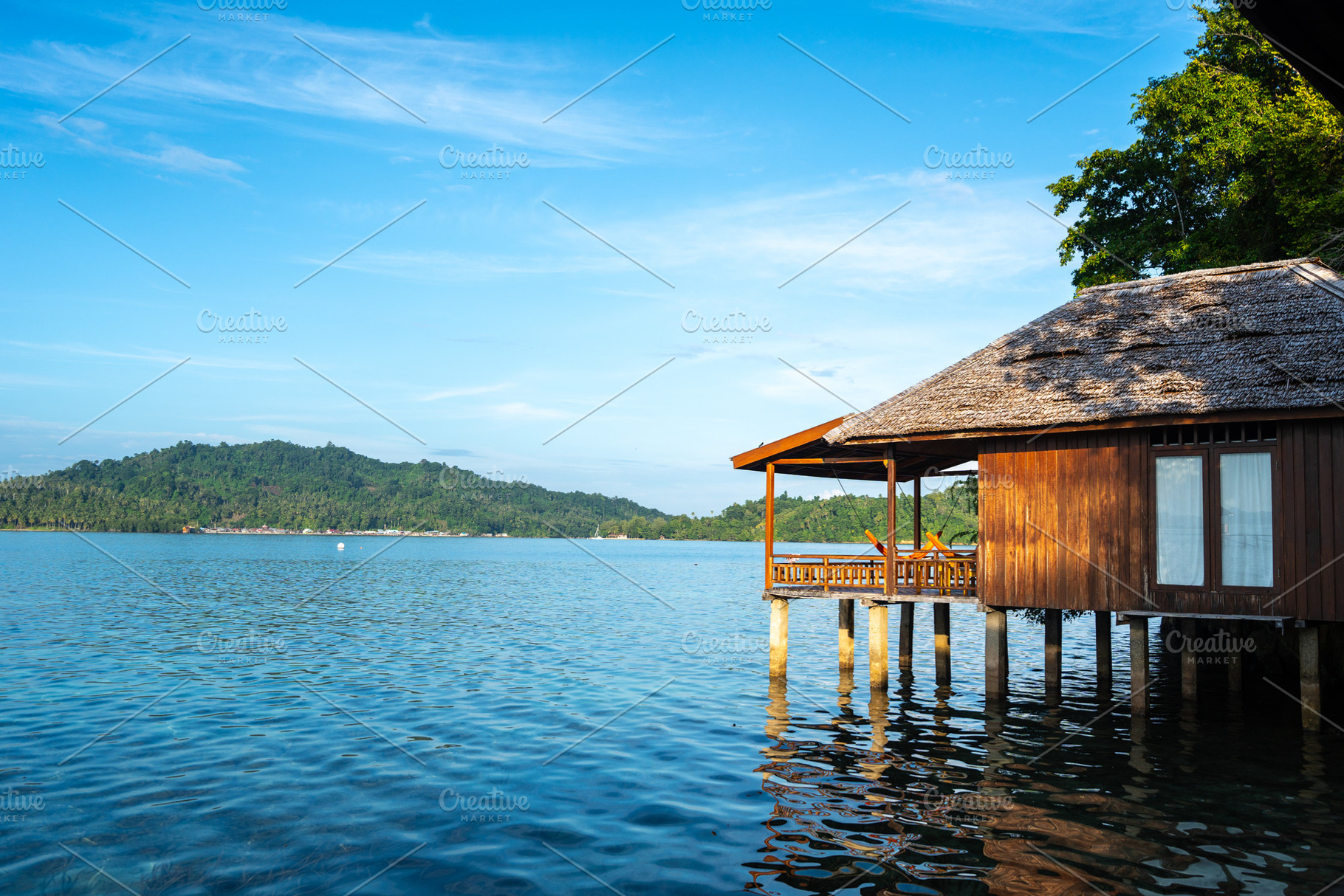 Sunset view of stilt house on Bolilanga Island, Togian archipela, an Architecture Photo by GoodGoods