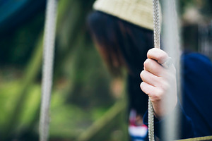 Lonely woman sitting on the swing, a Photo by Simmi Simons