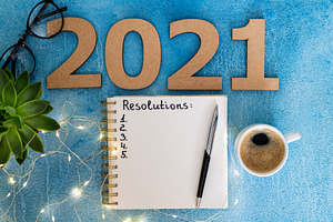New year resolutions 2021 on desk containing 2021, resolutions, and goals