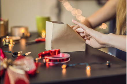 Young woman is packing presents, a Holiday Photo by Elizaveta Galitskaya
