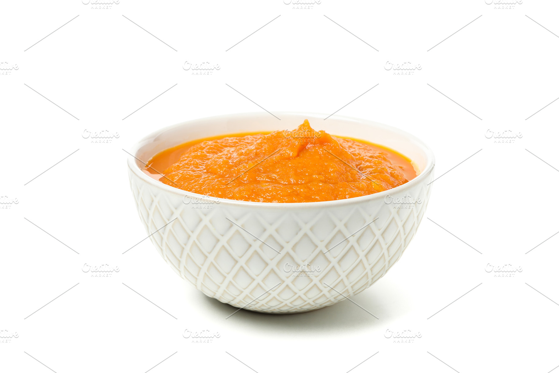 Bowl of pumpkin soup isolated on white background, a Food & Drink Photo by AtlasStudio PRO