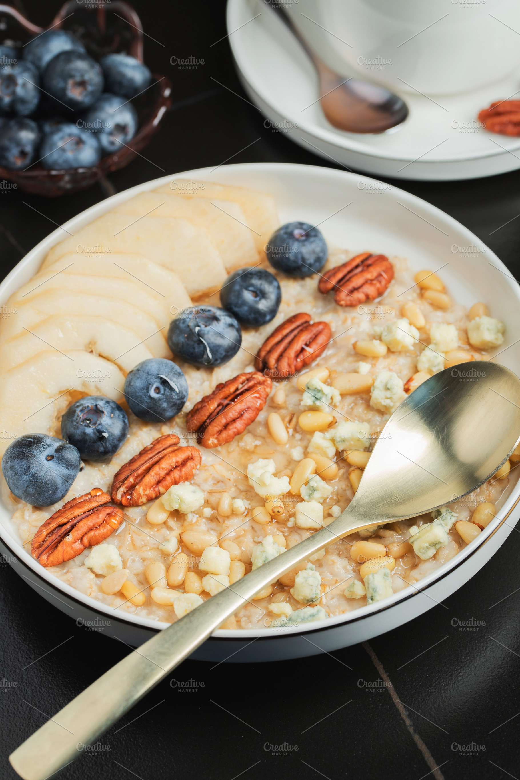 Oatmeal. Bowl of oatmeal porridge with blackberry, bananas and chia seeds on gr, a Food & Drink Photo by Budarinphoto