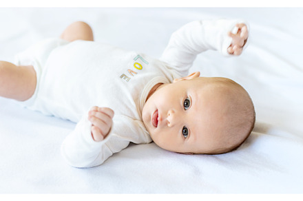 A newborn baby lies on a white bed, a Person Photo by yanadjana