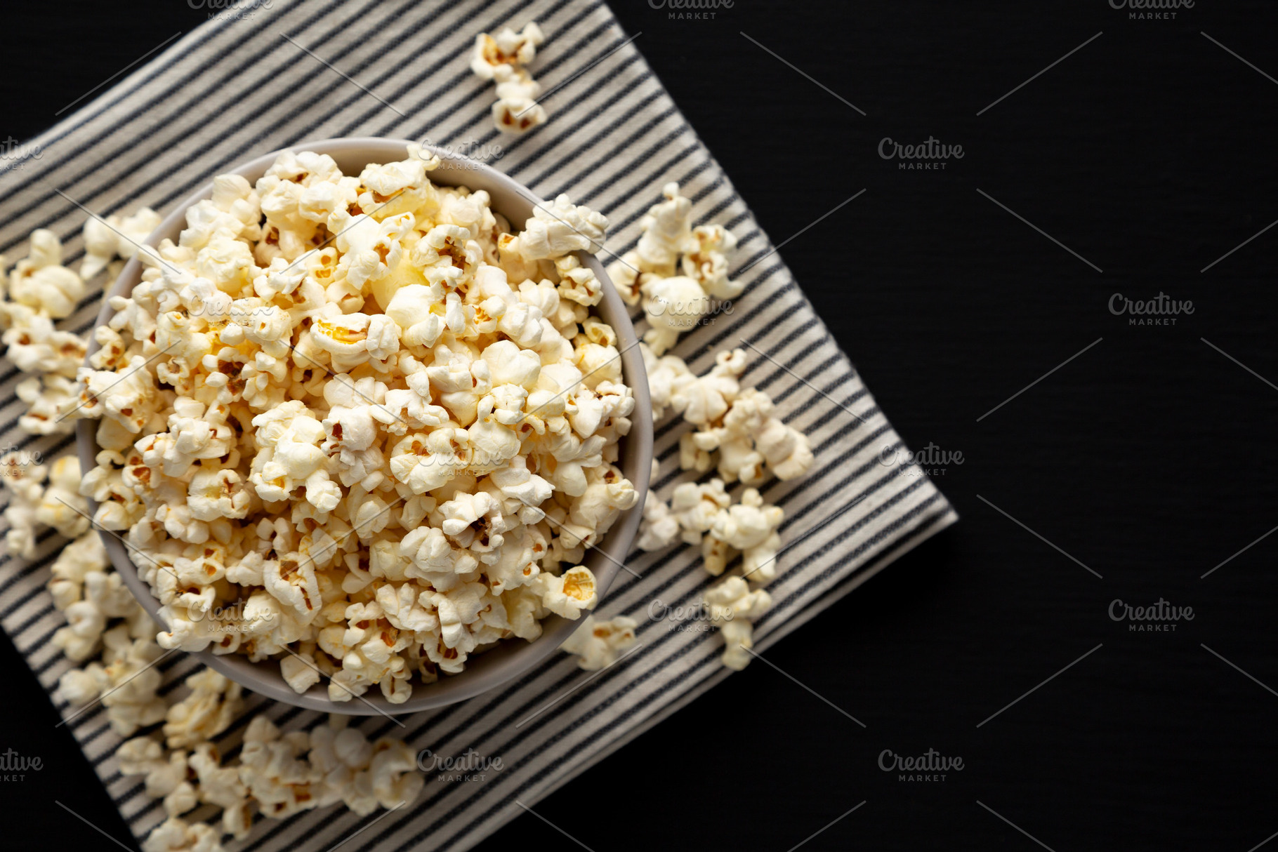 Homemade Butter Popcorn with Salt in a Bowl, top view. Copy spac, a Food & Drink Photo by LiudmylaChuhunova