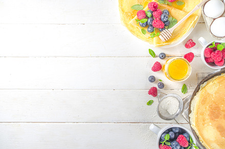 Crepes pancakes with berries, a Background Photo by Rimma