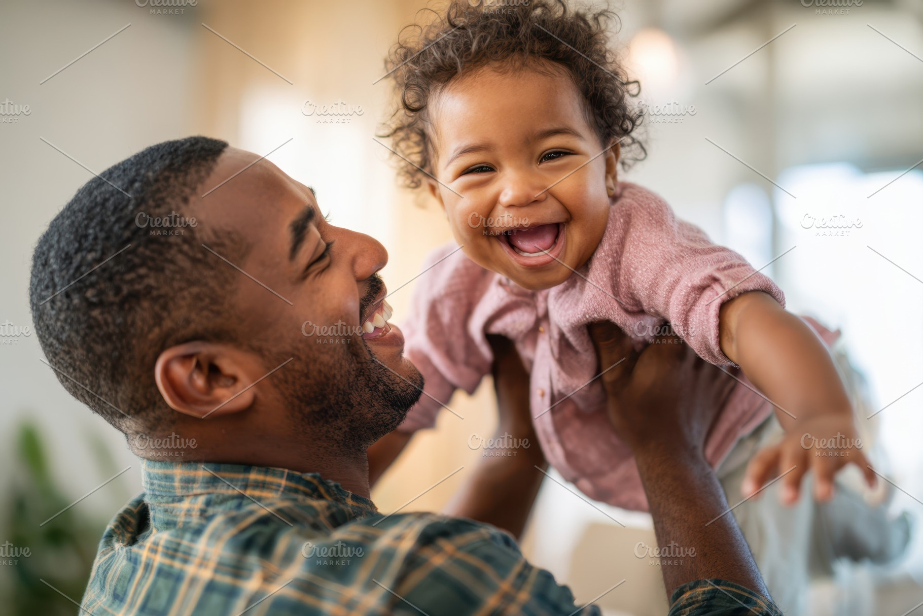 Father and toddler sharing a joyful moment at home, a Person Photo by AlyaAnd