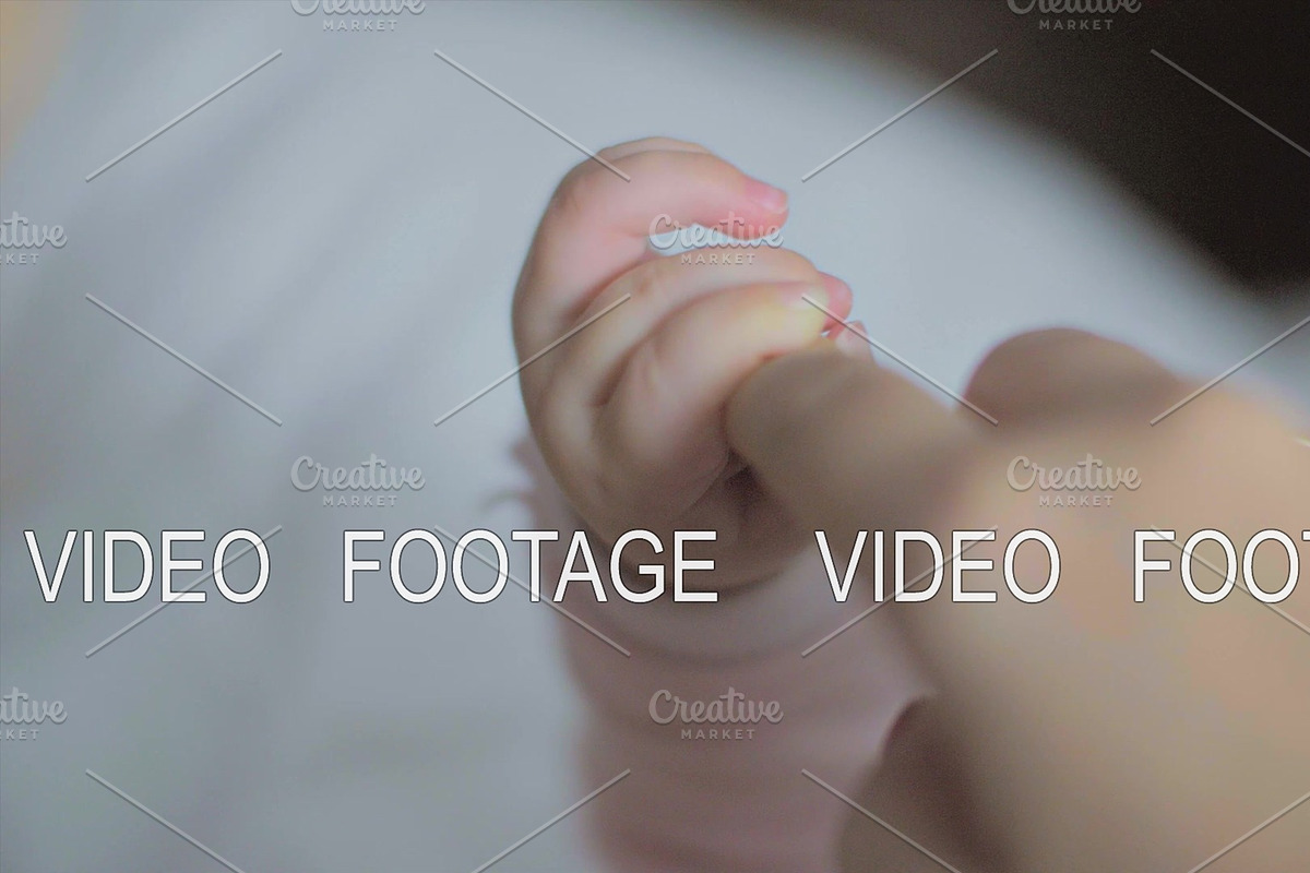 Baby daughter holding mum finger, a Graphic by Grey Coast Media (Photo 1 of 2)