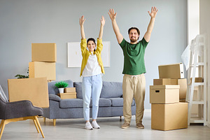 Couple Cheering Among Moving Boxes