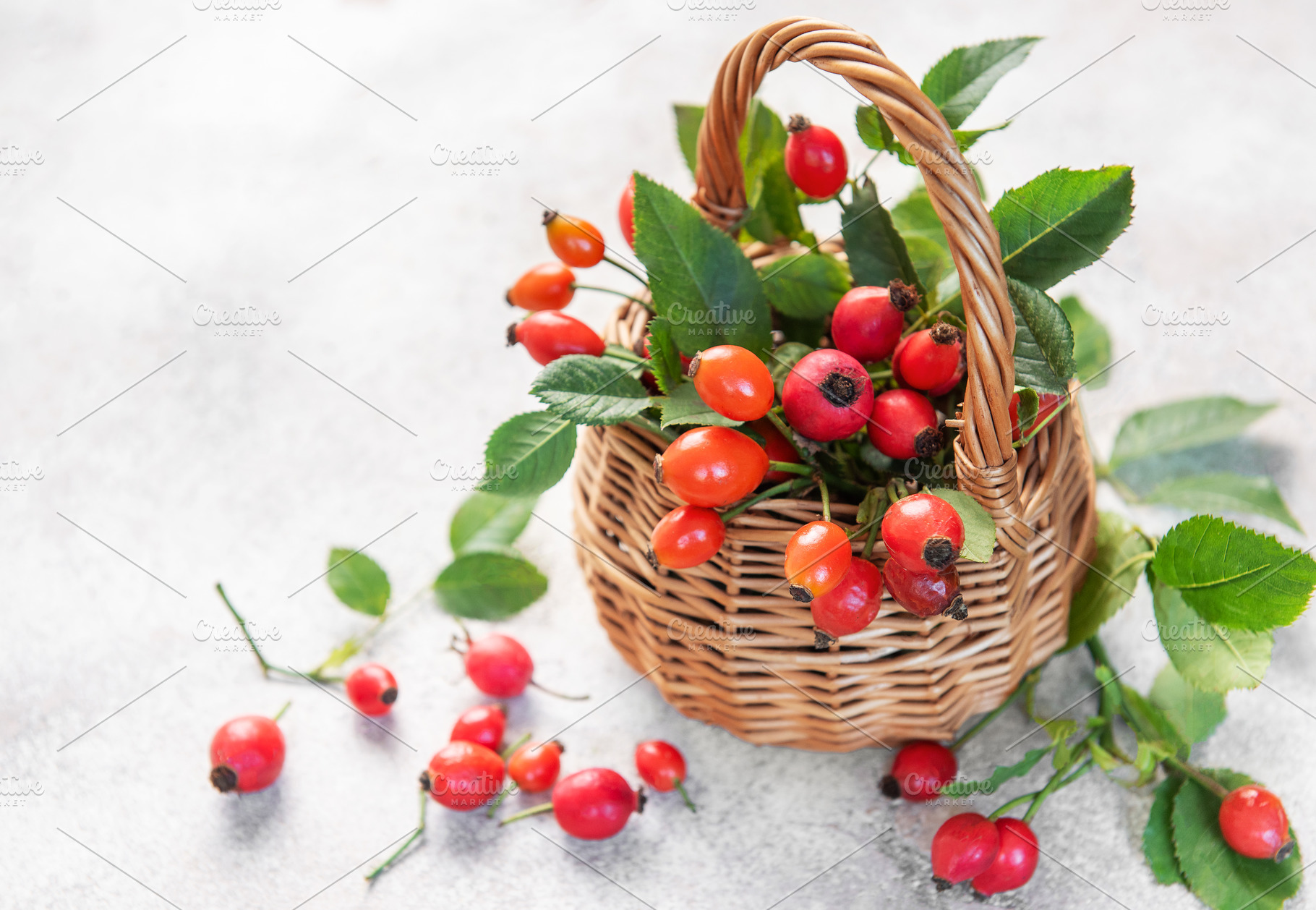 Wicker basket overflowing with freshly picked rose hips and gree, a Food & Drink Photo by Olena Rudo