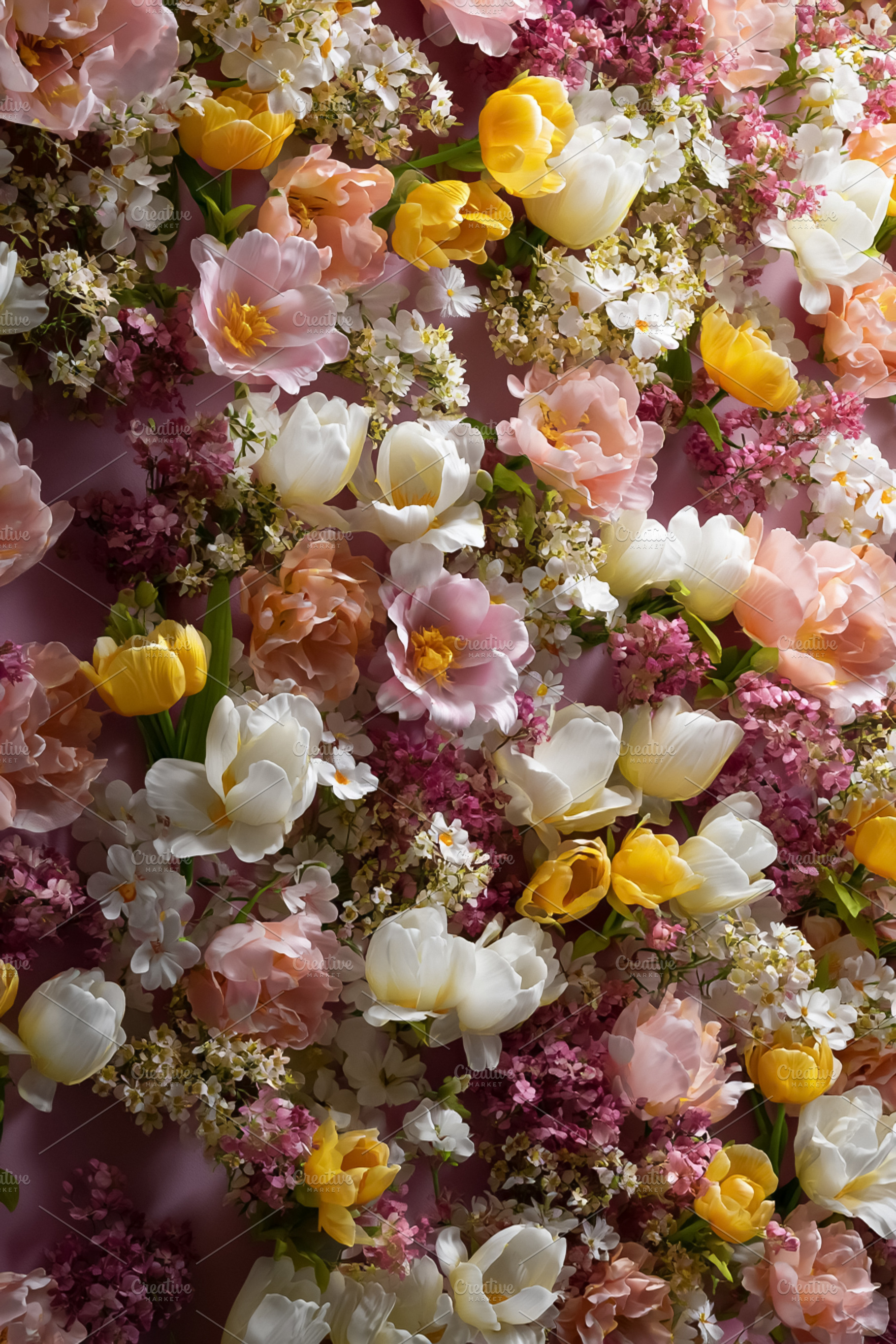 Spring flower wall with a mix of pink, yellow, and white tulips, a Photo by Studio ANNA