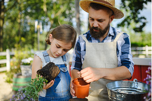 Father and young daughter planting, a Nature Photo by HalfPoint