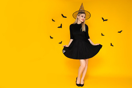 Concept of Halloween, young woman on yellow background, a Person Photo by AtlasStudio PRO
