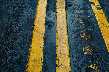 Faded yellow road lines blending int, a Photo by Iftikhar Alam