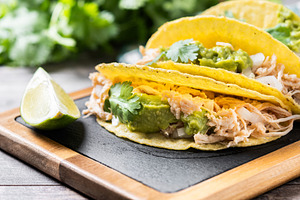 Mexican chicken tacos with guacamole and cilantro